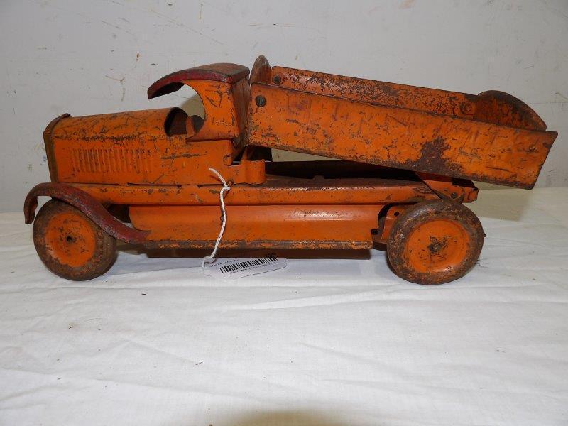 1920s-30s Turner Toys pressed steel dump truck: Shows heavywear with wobbly wheels.