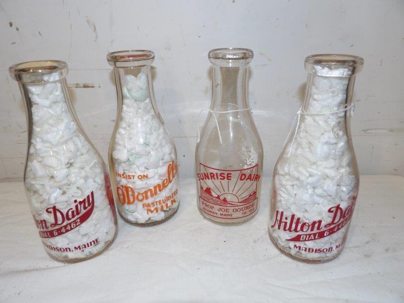Lot of four glass 1qt. milk bottles: Includes a Sunrise Dairy Jackman, Maine, 2- Hilton Dairy Madison, Maine, and O'Donnell's. All are in good condition and 9 1/2 in tall.