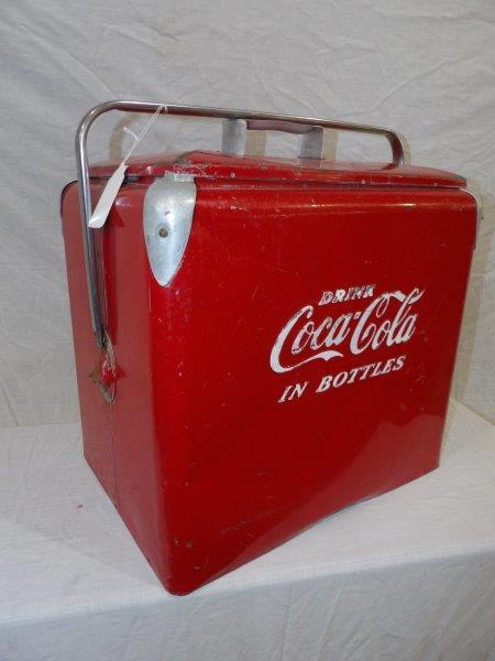 Coca-Cola cooler: With wear on lid and a few indentations on one side. 17 1/2 in wide 13 in deep 18 in tall.