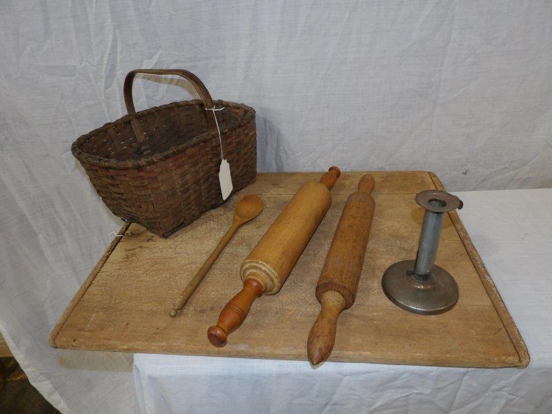 Early basket, bread board, rolling pins and misc.: Includes an early woven basket 12 1/2 in Long 9 1/2 in wide 6 in tall, bread/butterboard that is 18 in x 23 1/2 in, two rolling pins that are both 17" long, a wooden ladle and candle holder.