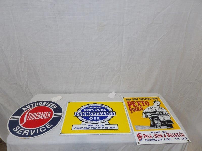 3- newer porcelain signs: Includes a Studebaker that is 11 1/4 in in diameter. A Pexto Tools and Pennsylvania Oil, both are 10 in x 14 in.