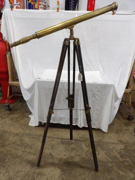 Early brass telescope with tripod: Unmarked brass telescope with tripod that has brass hardware. Telescope has a few minor dents. Overall has a great look! Telescope is approximately 39 in Long overall height with tripod is 62 in.