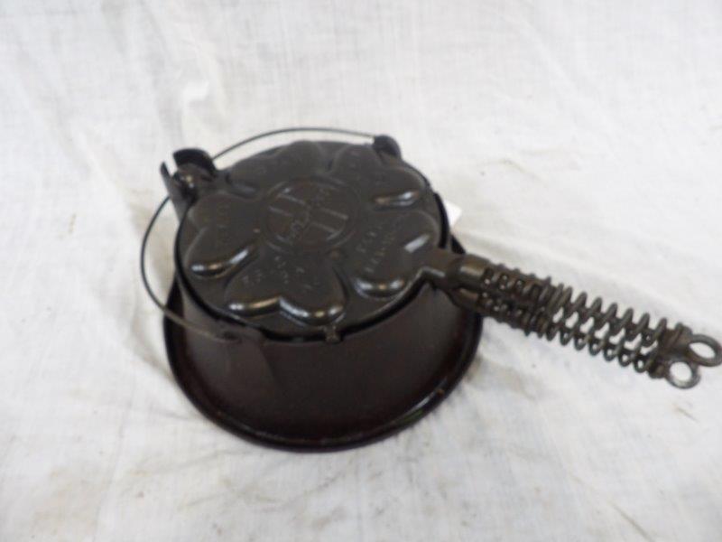 Griswold heart and star #18 waffle iron: With tall jacket and slant logo. Is in great condition! Appears to be seasoned and ready to use.
