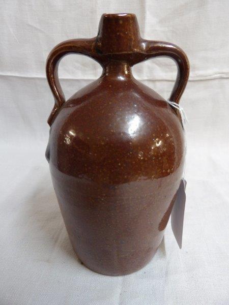 Small 2-handled sewer tile jug: Does have a repair on spout. Otherwise appears to be in good condition. 8 1/2 in tall.