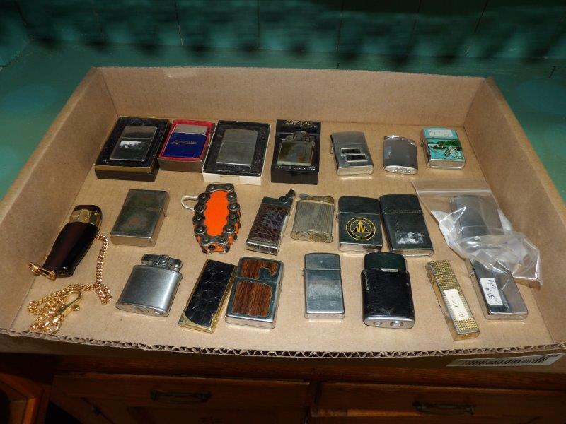 22 various lighters including a few Zippos: Includes five Zippos, several are with boxes, several are as is.