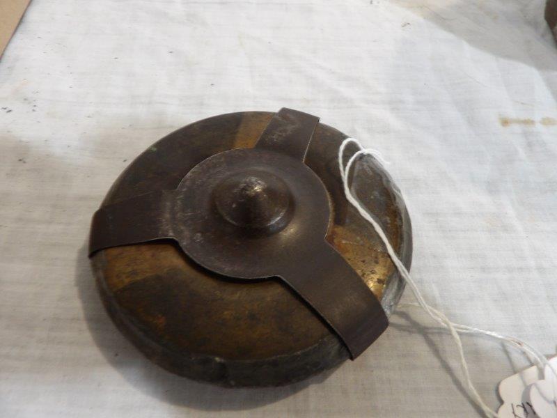 World War II landmine: Is Canada patented 1916. Appears to be a brass container with three finger cover. 4 in in diameter.