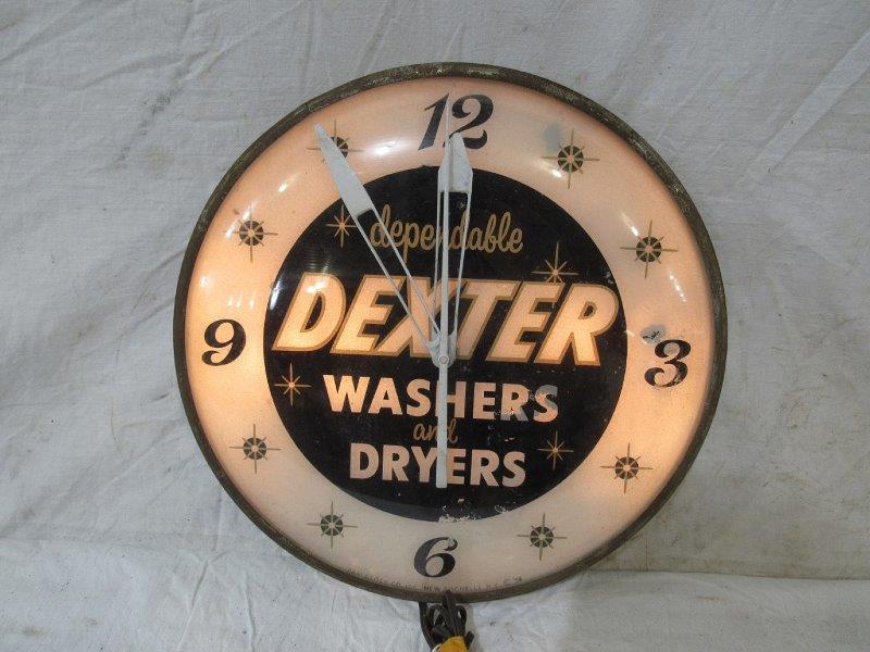 Dexter washers and dryers Pam clock: Clock lights up but does not run. Glass dial has spotting throughout and a few small areas of peeling. Has areas of corrosion on can and ring. 15 in diameter.