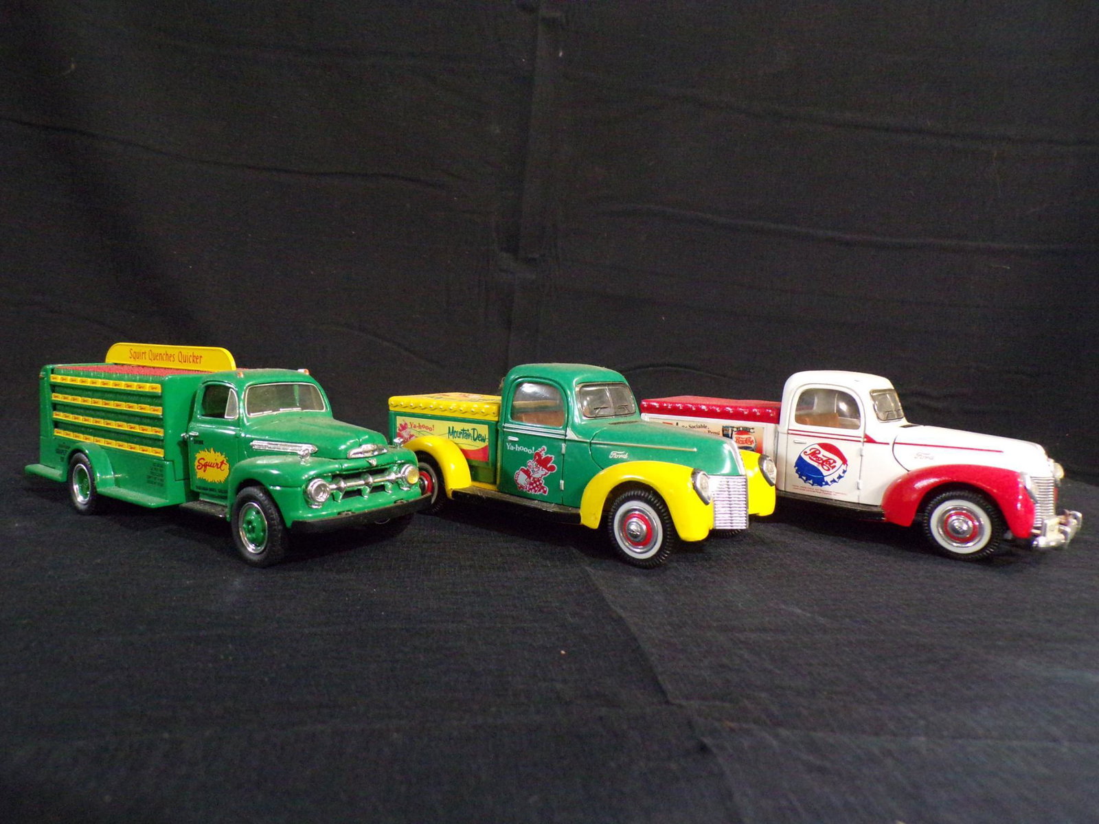 Mountain Dew, Pepsi and Squirt trucks: All are newer toys but display well.