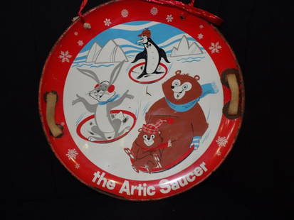Metal Arctic Saucer sled: Depicting animals and has nice bright colors with some scuffing and scratches and some wear along rim. Appears to have original nylon handles. 26 in diameter.