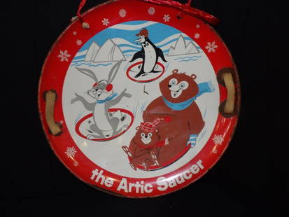 Metal Arctic Saucer sled: Depicting animals and has nice bright colors with some scuffing and scratches and some wear along rim. Appears to have original nylon handles. 26 in diameter.