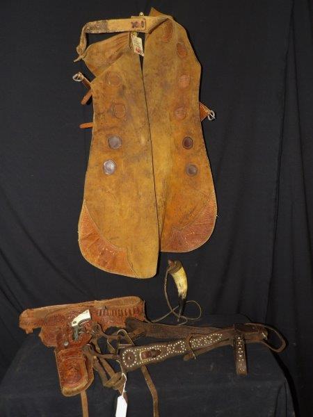 LEATHER CHAPS, HOLSTER BELT WITH HUBLEY CAP GUN AND HARNESS: GREAT SET OF WORKING BATWING CHAPS. BROWN COWHIDE. LEATHER HORSE HARNESS. LEATHER HOLSTER AND BELT WITH HUBLEY CAP GUN. LANCASTER, PA. MADE IN USA. ALSO HAS A POWDER HORN ON LEATHER STRAP.