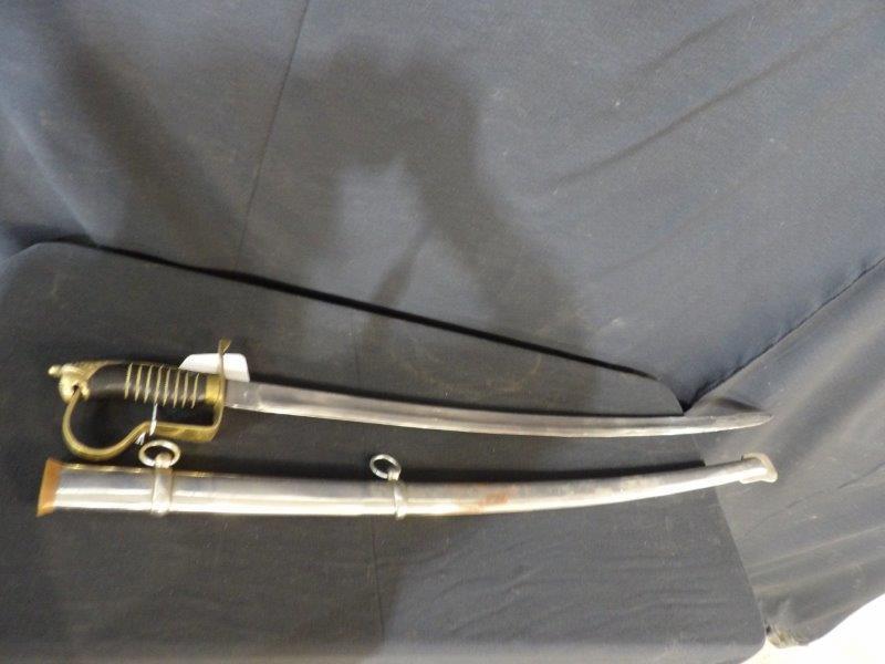 OFFICERS SWORD: BRASS GUARD WITH LION HANDLE. WHITE METAL HARDWARE. SOME RUST IF FORMING ON OUTER SHEATH. 37 1/2 INCHES LONG FROM TIP TO HANDLE.