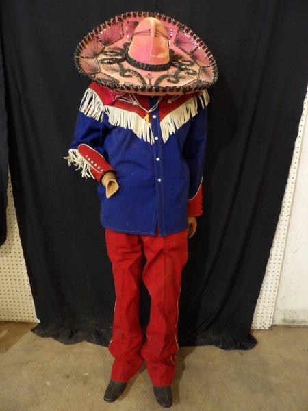 CAPTAIN KANGAROO OUTFIT: MANNEQUIN DRESSED WITH A CAPTAIN KANGAROO DRESS SHIRT, BANDANA, PANTS, SOMBRERO, AND CAST IRON BOOTS. THIS MANNEQUIN DOES NOT HAVE A HEAD AND IS MISSING ONE HAND. APPROX 5 FT TALL.