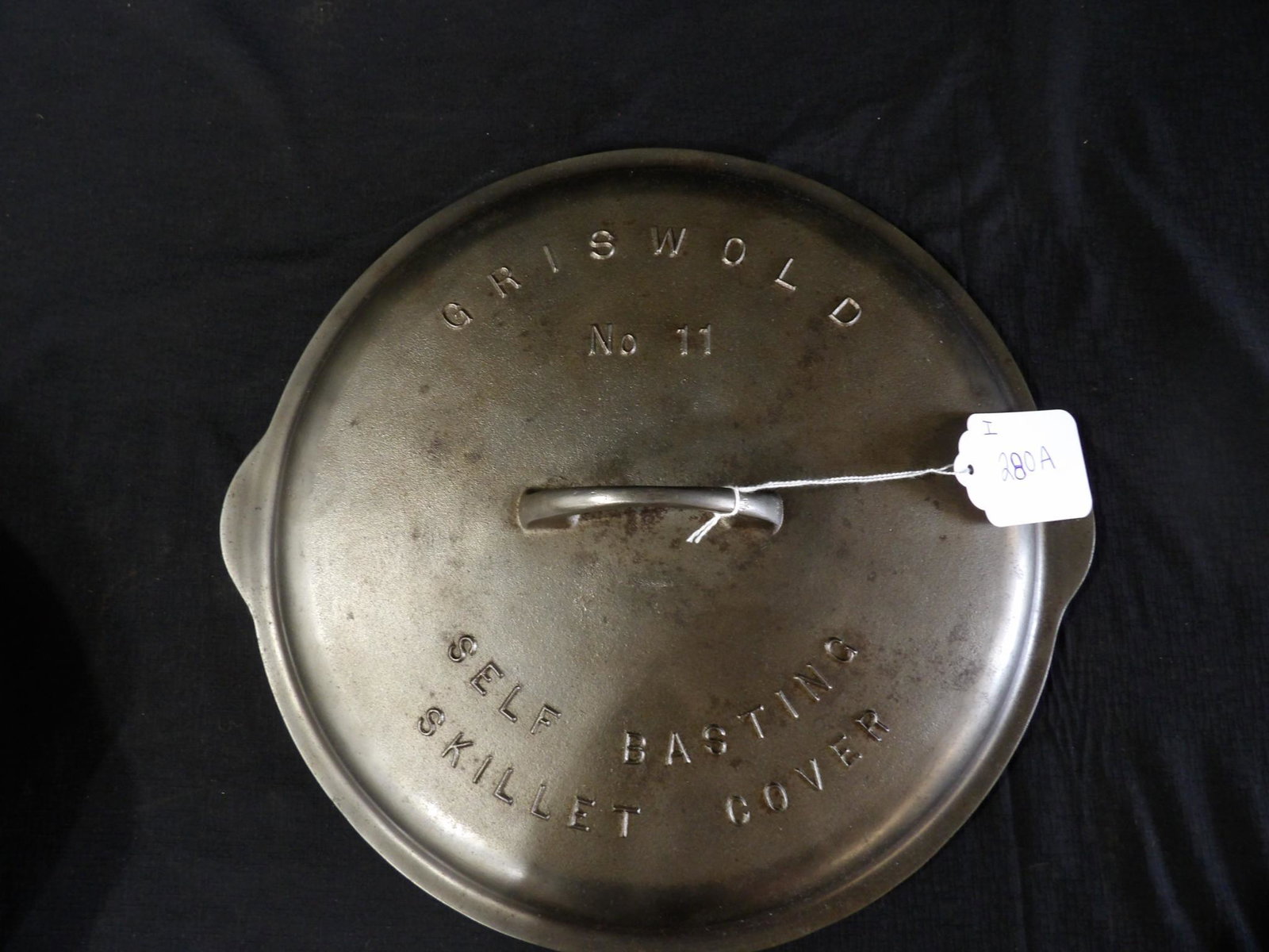 Griswold #11 self-basting cover: Embossed top and is also marked on underside, in nice clean condition! Lid only.