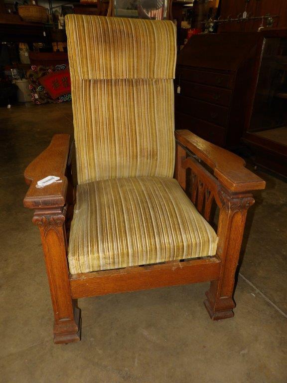 Quarter Sawn Oak Vintage Reclining Chair.: Carved wood legs and arms. Reclines as it should. Upholstery has slight staining and a small hole in seat.