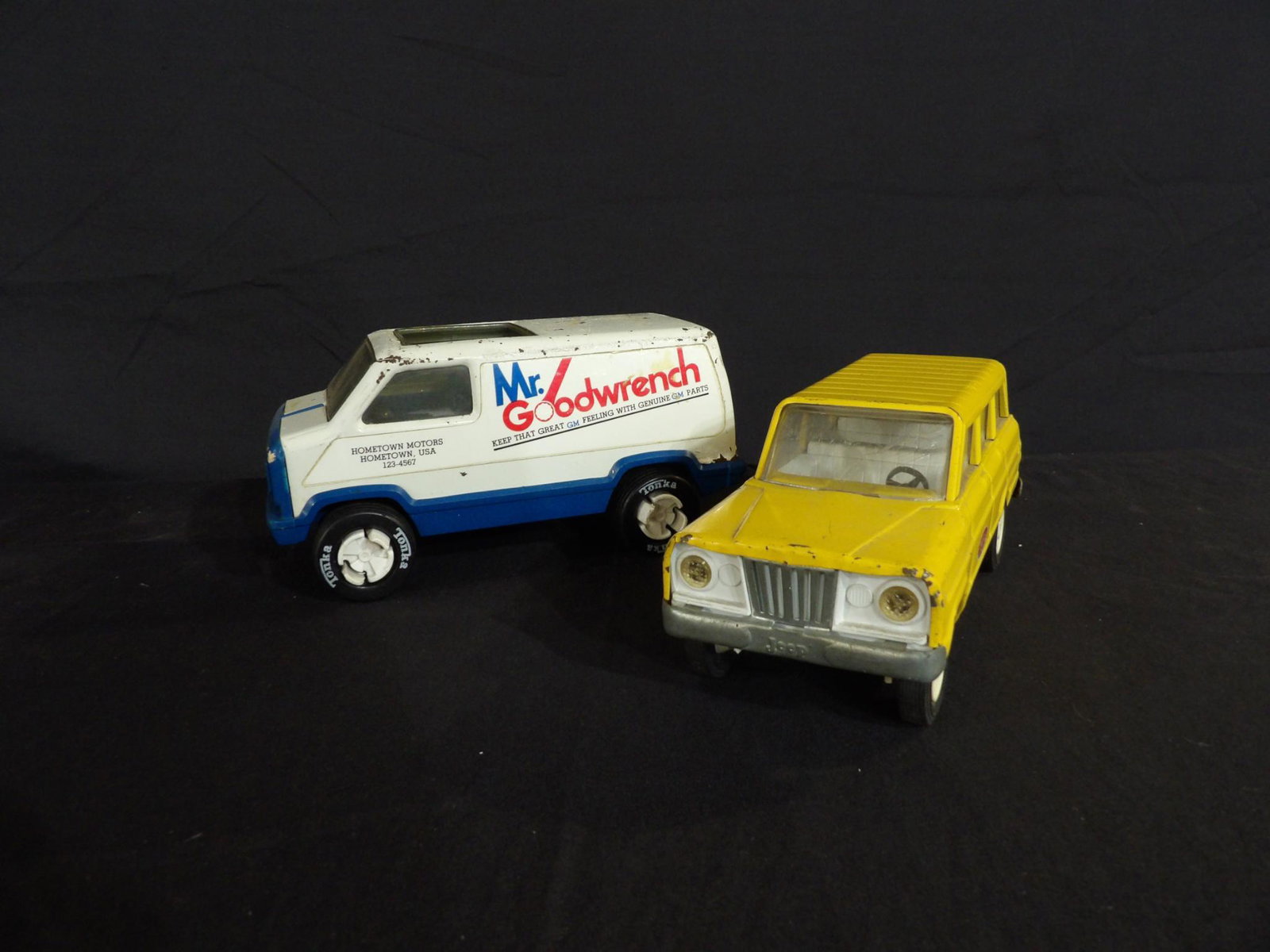 LOT OF 2 VINTAGE TONKA TOY REPLICAS-MR. GOODWRENCH VAN & TONKA JEEP: OUT OF BOX IN USED CONDITION SHOWING CONDITION ISSUES AS IN LABEL LOSS, PAINT LOSS, SCRATCHING, DENTING AND POSSIBLY SOME MISSING PARTS AS MAY BE SEEN IN PHOTOS. 8 1/2" TO 9" L
