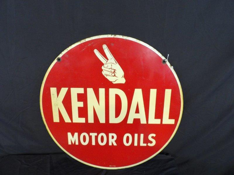 DST Kendall motor oils sign: With some scuffing and minor Edge wear, also has some yellowing in white otherwise a good clean sign that displays very well! Is marked MCA 1988. 24-in diameter.
