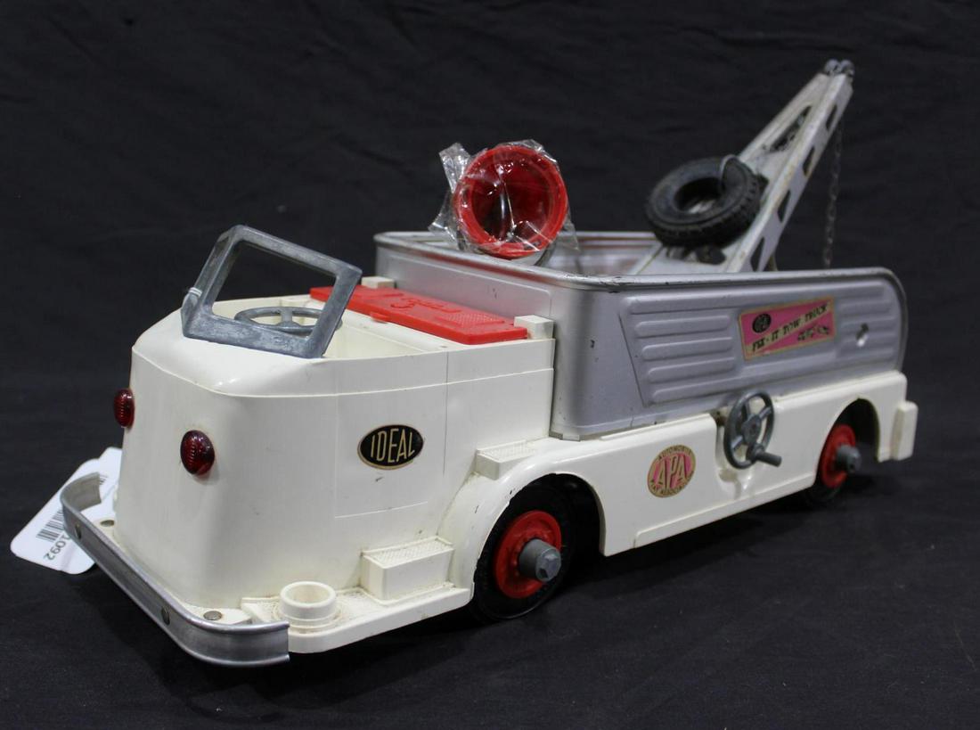 1950's Ideal Toy Co. Fix-It tow Truck: Plastic truck with die-cast trim and accessories, in its original state. No bulb in beacon light, and comes with spare tire. In nice cond. 17" long.