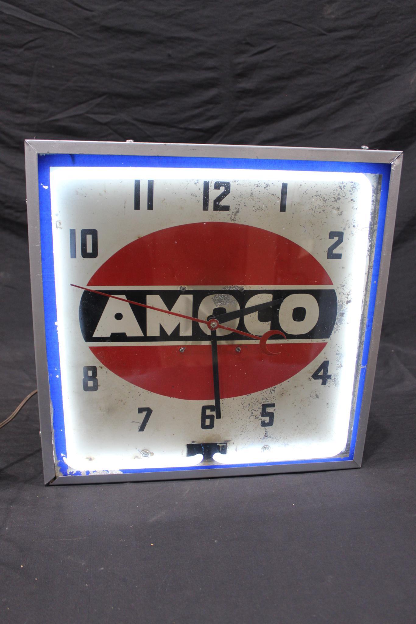Nice Amoco Neon clock: Shows some chipping paint on metal dial, has a crack or repaired crack in neon, but lights and runs as it should, also shows paint splatters on back and side of can, is missing rear access panel. Over