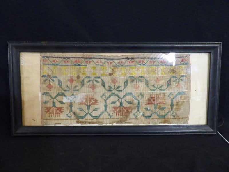 Early Floral Embroidery Sampler: Some water damage, and thinning areas. A few heavy soiling areas and one smaller hole. 21 1/2 x 9 1/2.