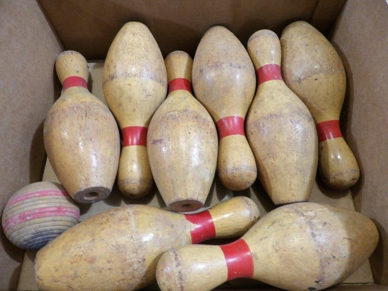 WOODEN BOWLING PINS: 8 PINS AND ONE WOODEN BALL. EACH PIN IS 9.5 INCHES TALL.