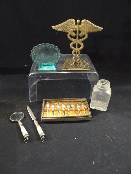 DOCTORS BOOK HOLDER, GLASS BOTTLE, & MORE: HEAVY CORN HOLDERS, MOTHER OF PEARL MAGNIFYING GLASS AND LETTER OPENER.