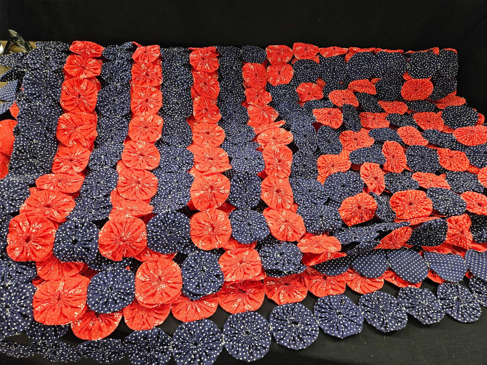 RED WHITE & BLUE YOYO QUILT: 78 INCHES LONG X 90.