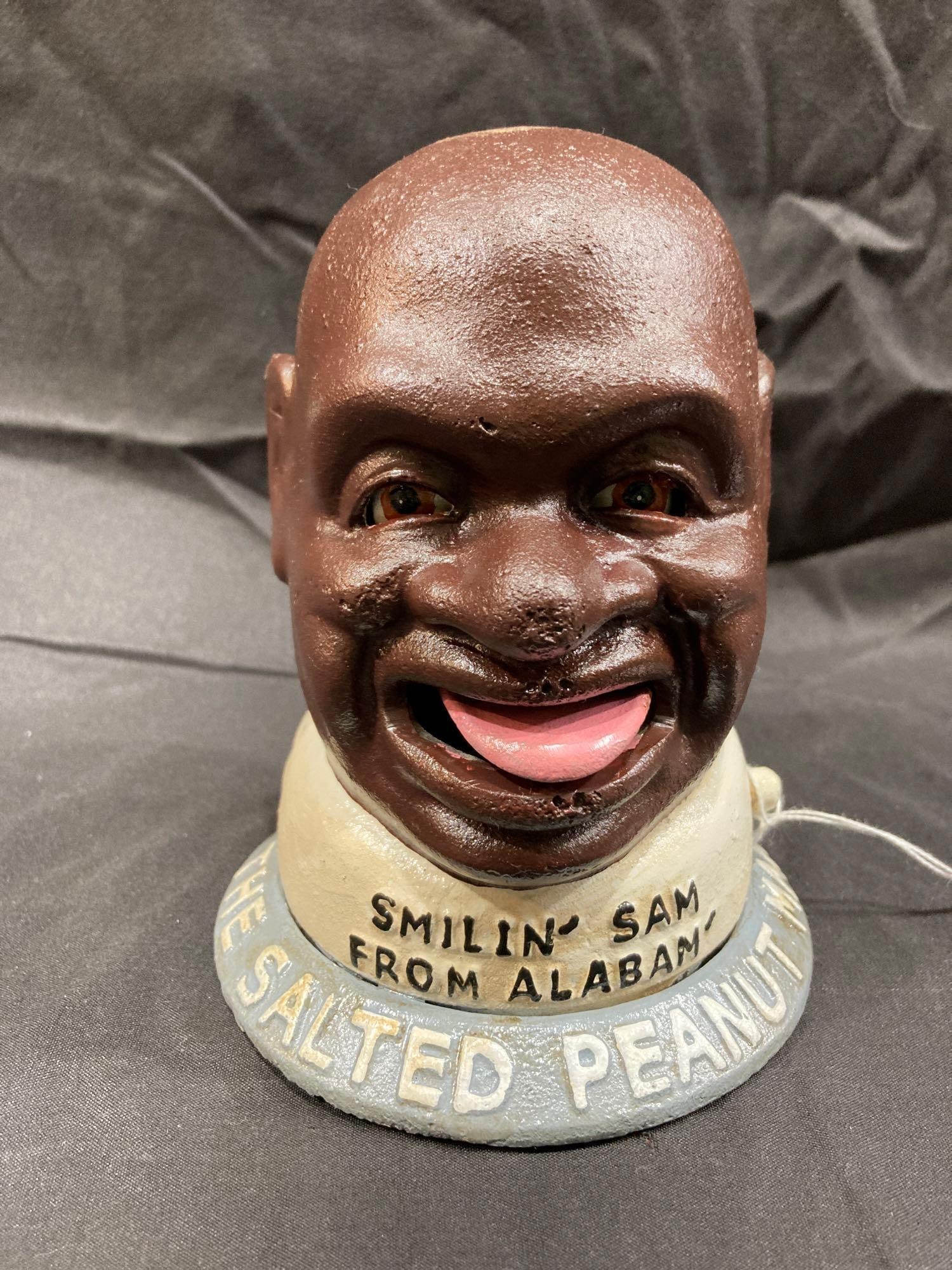 SMILIN SAM BANK: CAST IRON, 6 INCHES TALL. THIS IS A NEWER CAST IRON PIECE