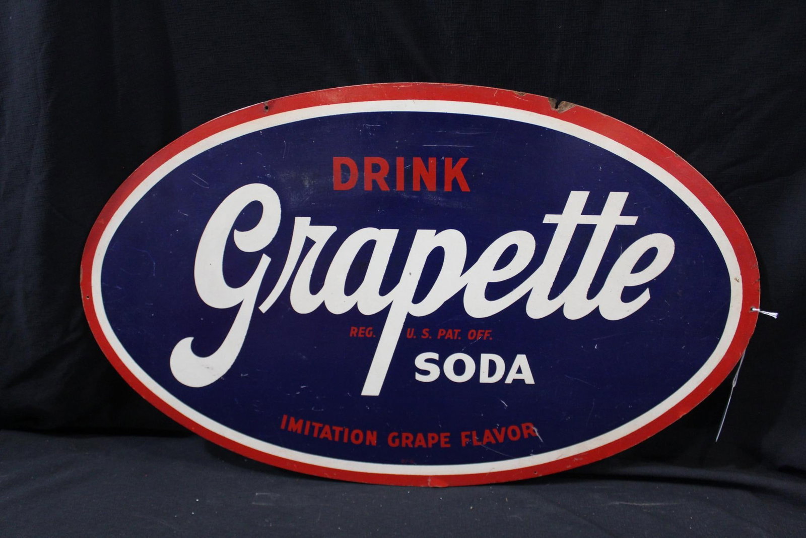 Grapette Soda Masonite sign : Single sided masonite sign with a few scuffs and a chip on top mounting hole, but displays well. 17 x 27 3/4 .