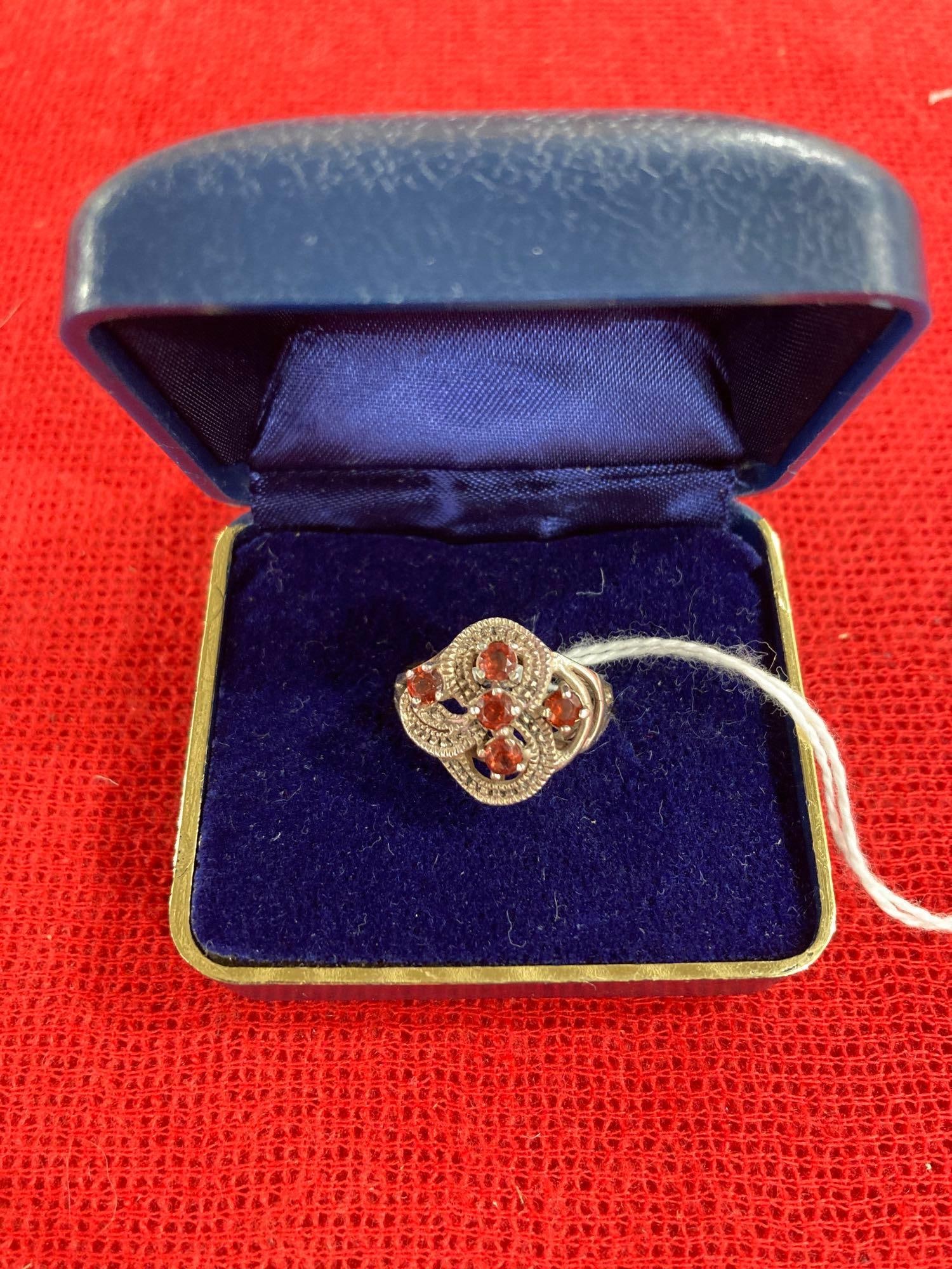 STERLING SILVER AND GARNET RING: MARKED .925. SIZE 8