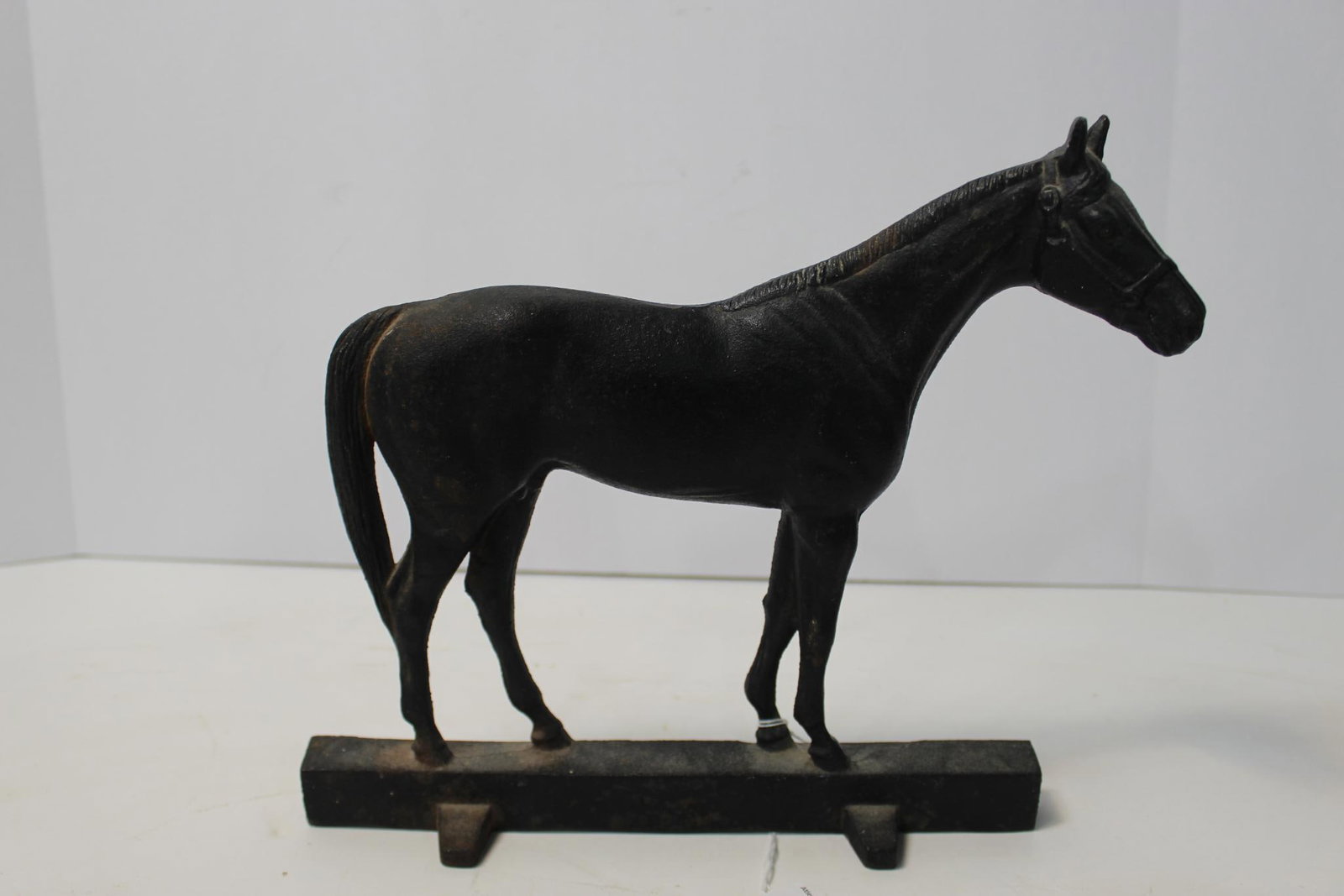 CAST IRON HORSE DOOR STOP: HAS AREAS OF SURFACE RUST 11X9.5 IN