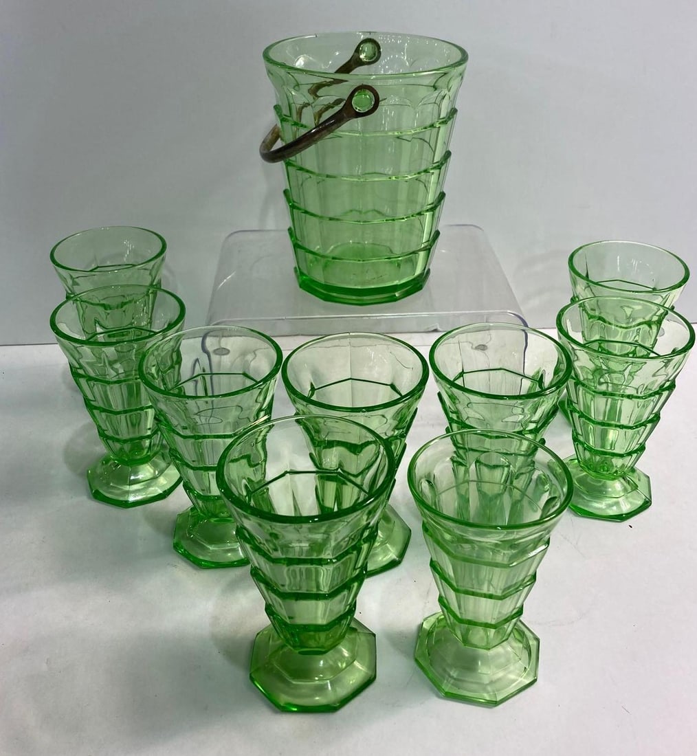 10 PIECE URANIUM GLASS AND ICE BUCKET: All pieces are in very good condition. one glass in half an inch shorter than the others but has the same pattern. Ice bucket is 6.5 inches tall x 5 inch diameter.