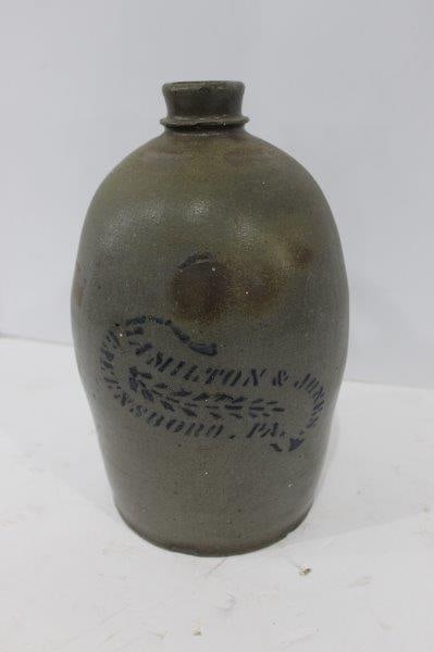 Hamilton and Jones Stoneware Jug: Greensboro PA. A small spider crack on rear near handle. No major chips although a makers flaw shows near top of handle. 12 inches tall