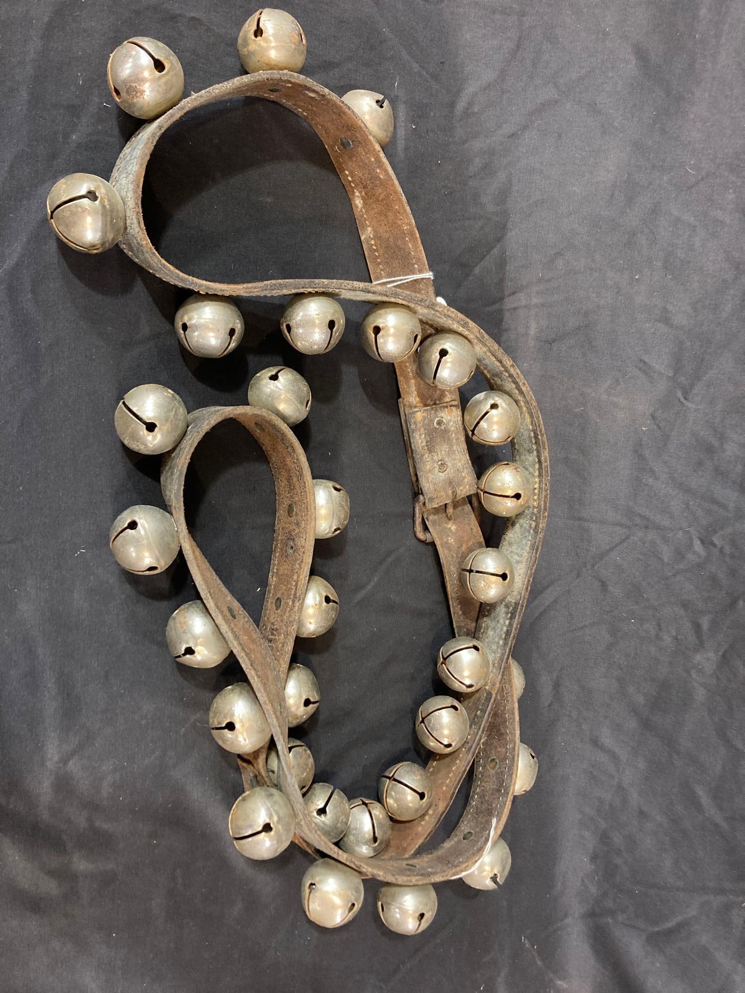 Srand of sleigh bells: 31 bells on leather belt.