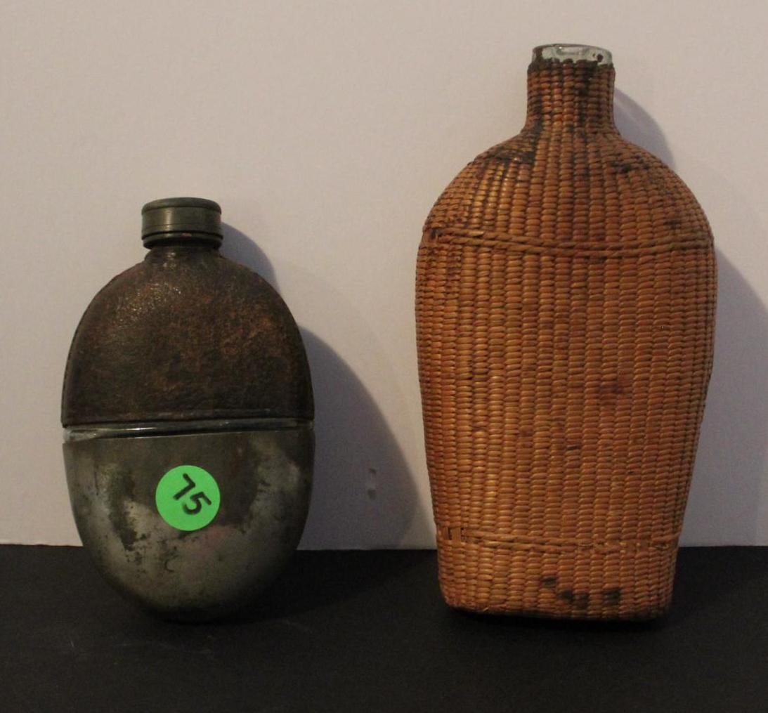 Pair of Glass Flasks: One flask is covered in a wicker weaved holder and other is leather and metal. Both are in very good condition. 5 and 7 inches long