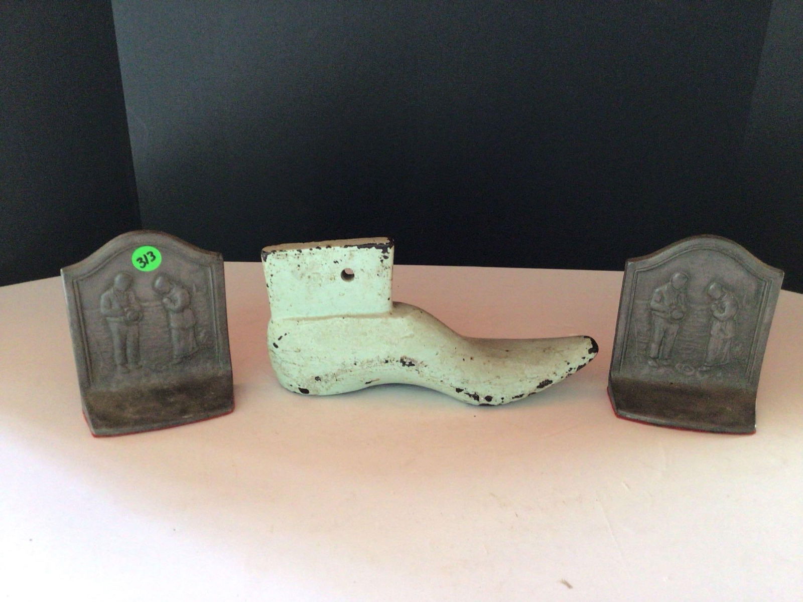 The Angelus Call to Prayer cast bookends and Heavy metal shoe form: Shoe form is heavy and 10in long. Bookends are marked copyright 1927.