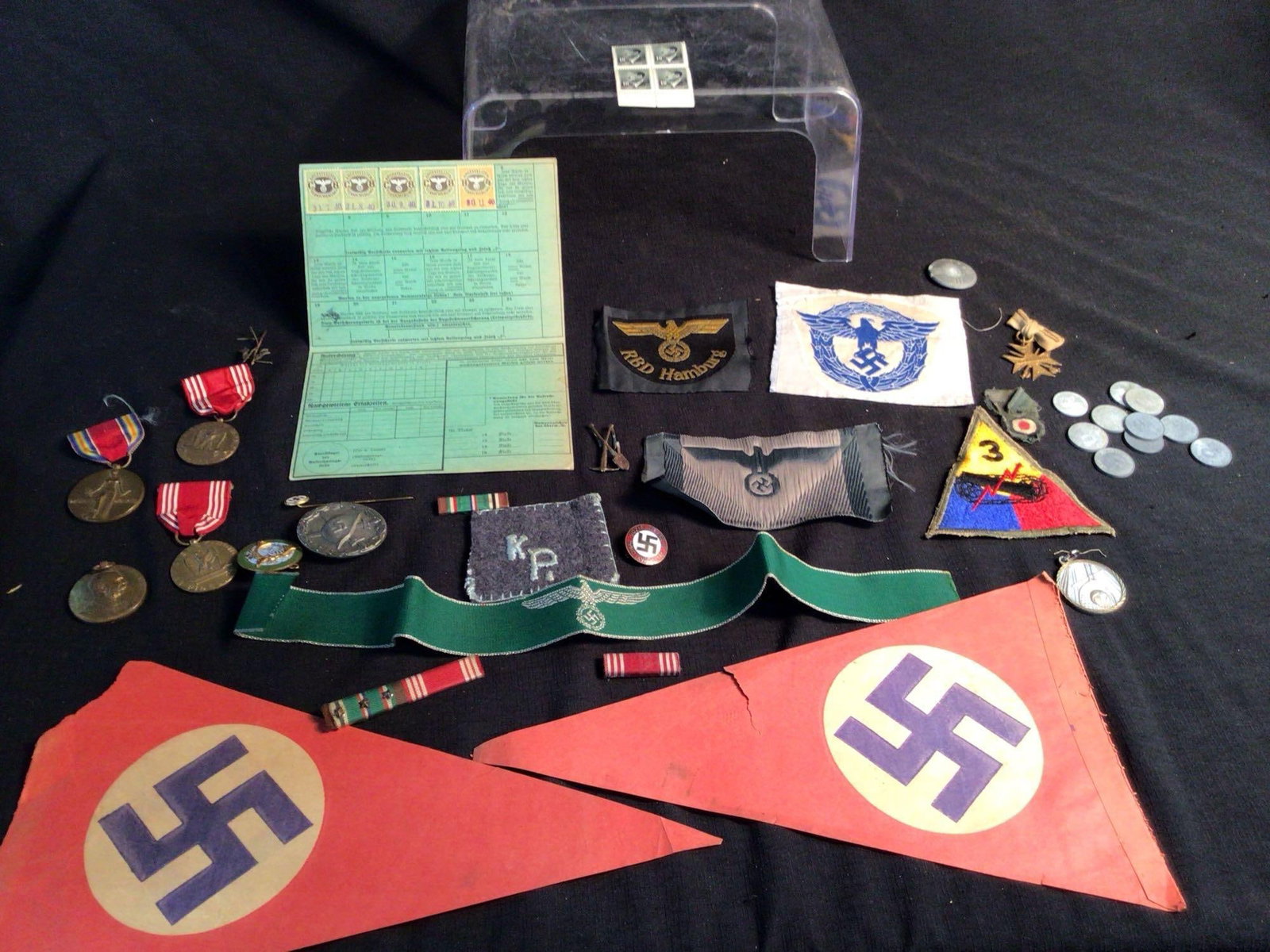 Large lot of German Nazi badges, pins and tokens: Includes Hitler stamps, war badges, paper flags, German paper items