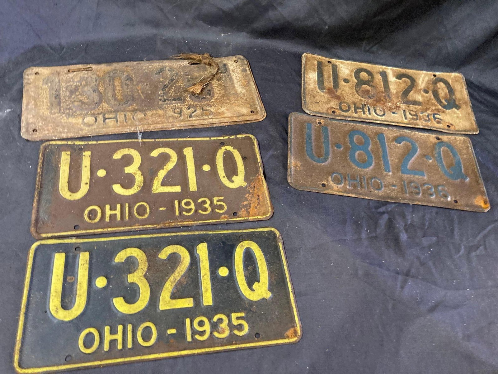 1925, 1935, and 1936 License Plates: Each are matching pairs. Some may show minor rusting