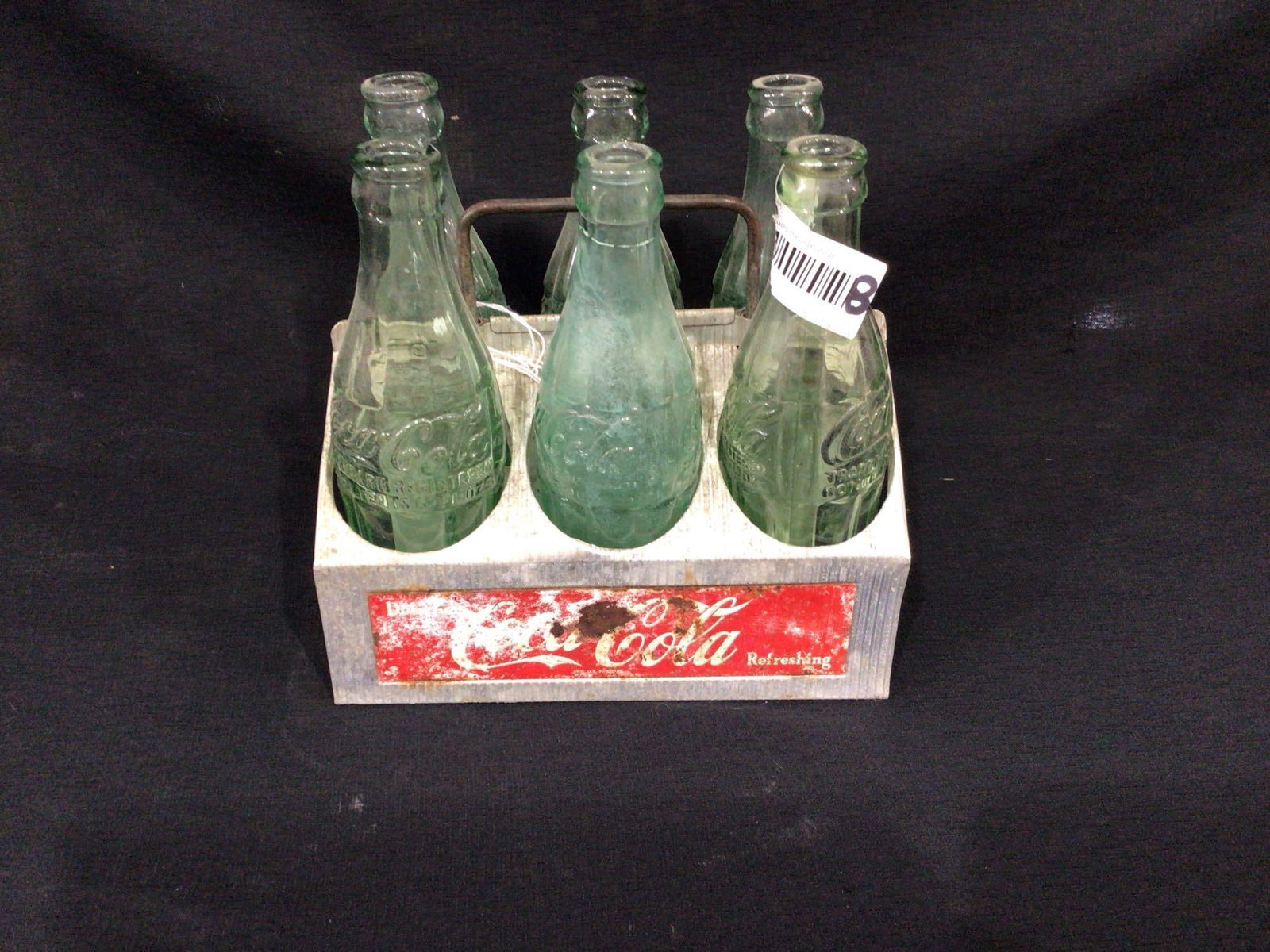 Coca Cola Bottles and Carrier: Carrier shows some wear. bottle bottoms are marked Greensboro, Lexington, Concord, and Thomasville NC