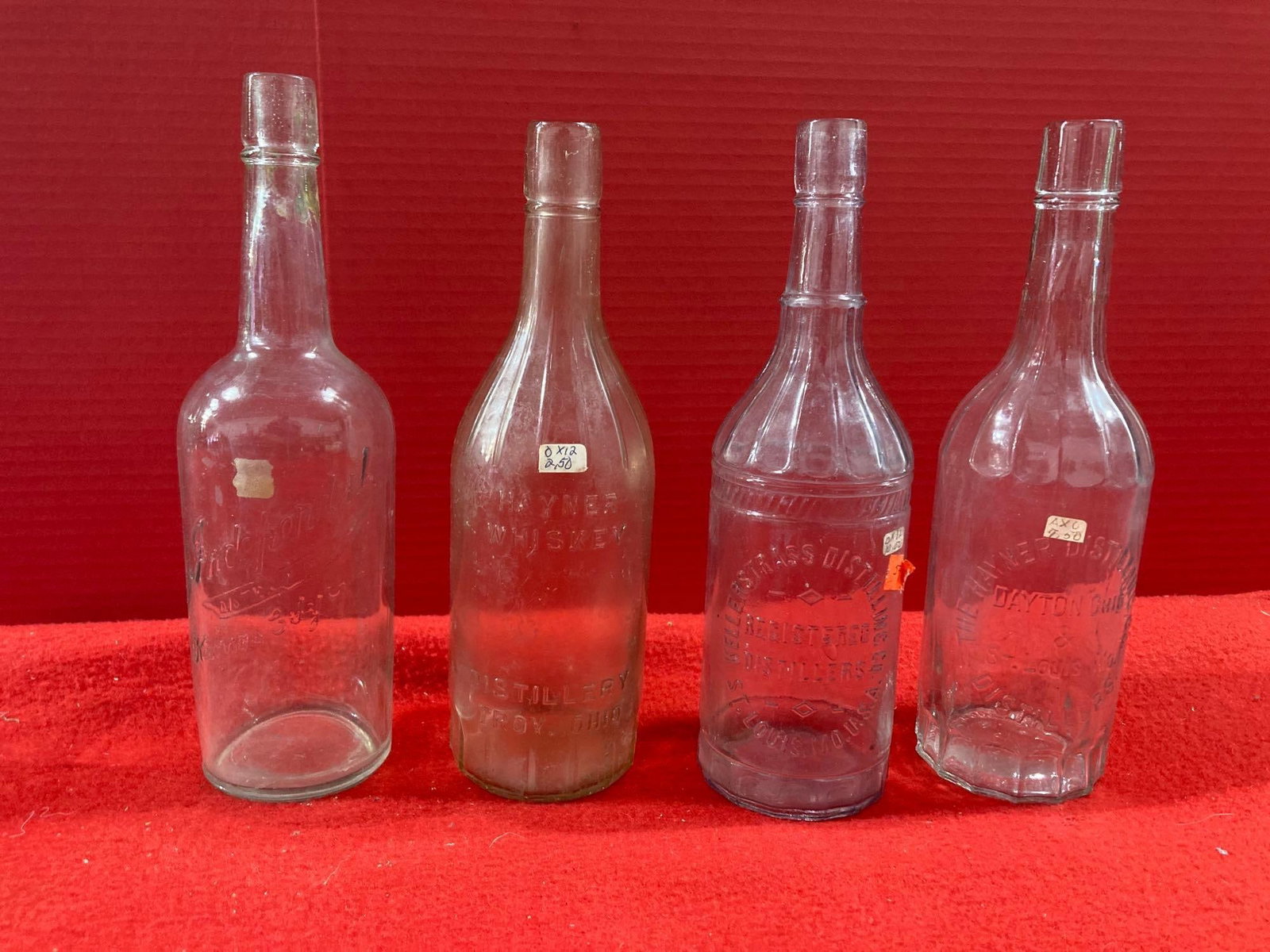 WHISKEY AND DISTILLERY EMBOSSED BOTTLES: THE HAYNER DISTILLERY, KELLER STRASS, AND INDEPENDENT. LOT OF 4 ALL HAVE BLOB TOPS