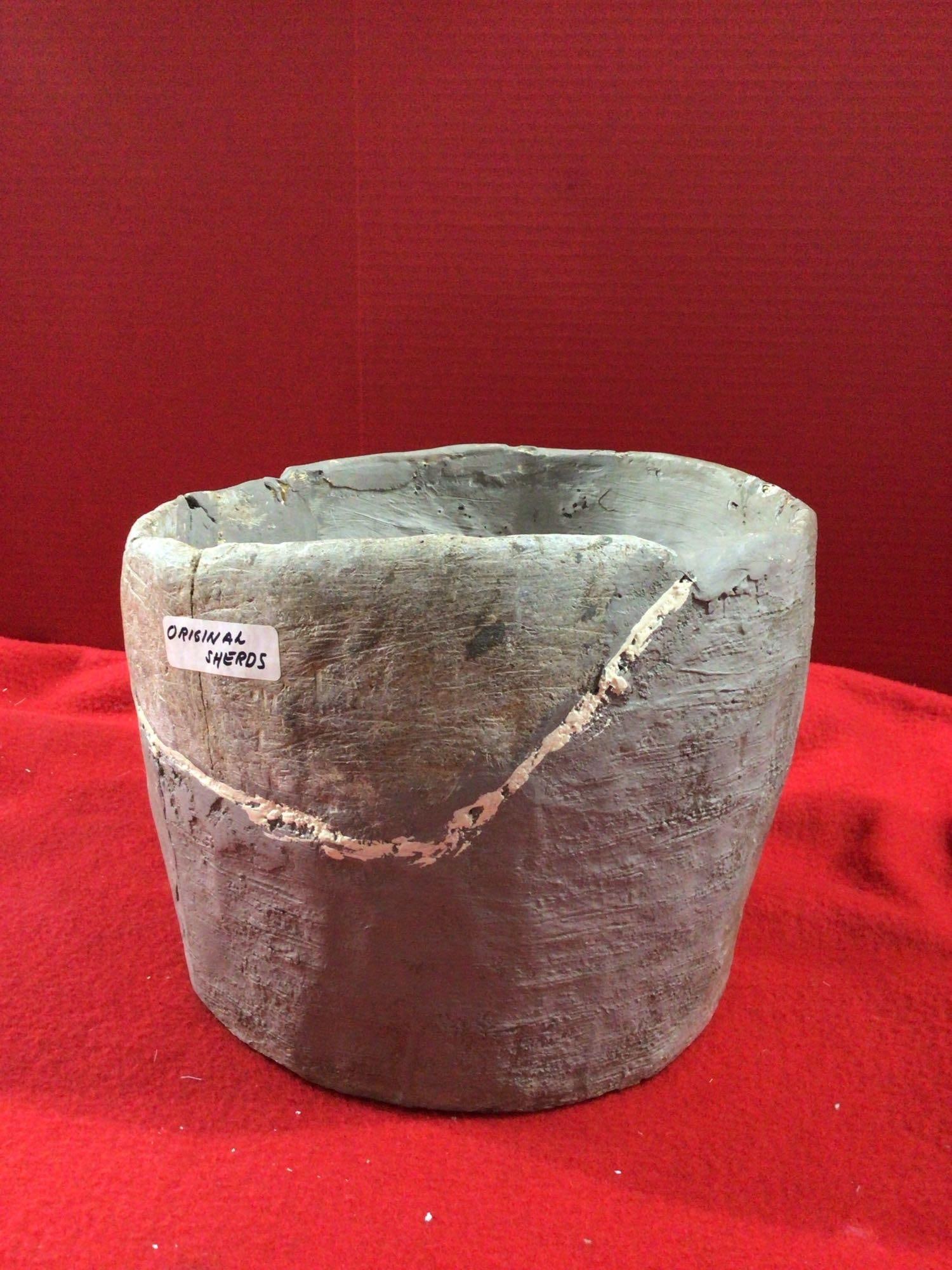 SOAPSTONE BOWL OF SHERDS: RECONSTRUCTED FROM SHERDS TO SHOW SIZE. SHERDS FOUND IN N. CAROLINA. 11IN TALL X 9