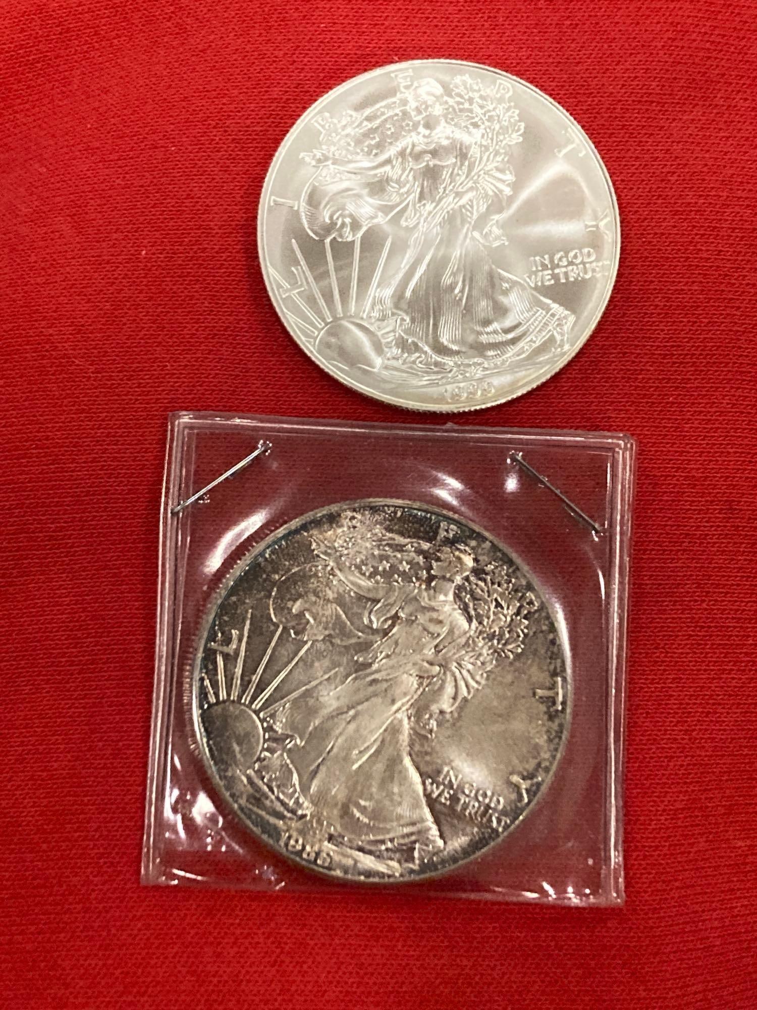 1999 AND 1986 $1 SILVER EAGLES (1 of 5)