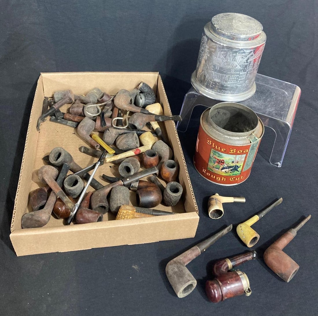 HUMIDOR TOBACCO CAN AND PIPES: METAL HUMIDOR IS ETCHED W EARLY DESIGN, INCLUDES MANY PIPES OF VARIOUS PATTERNS AND SIZES