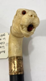 HAND CARVED LION DRESS CANE WITH GARNET