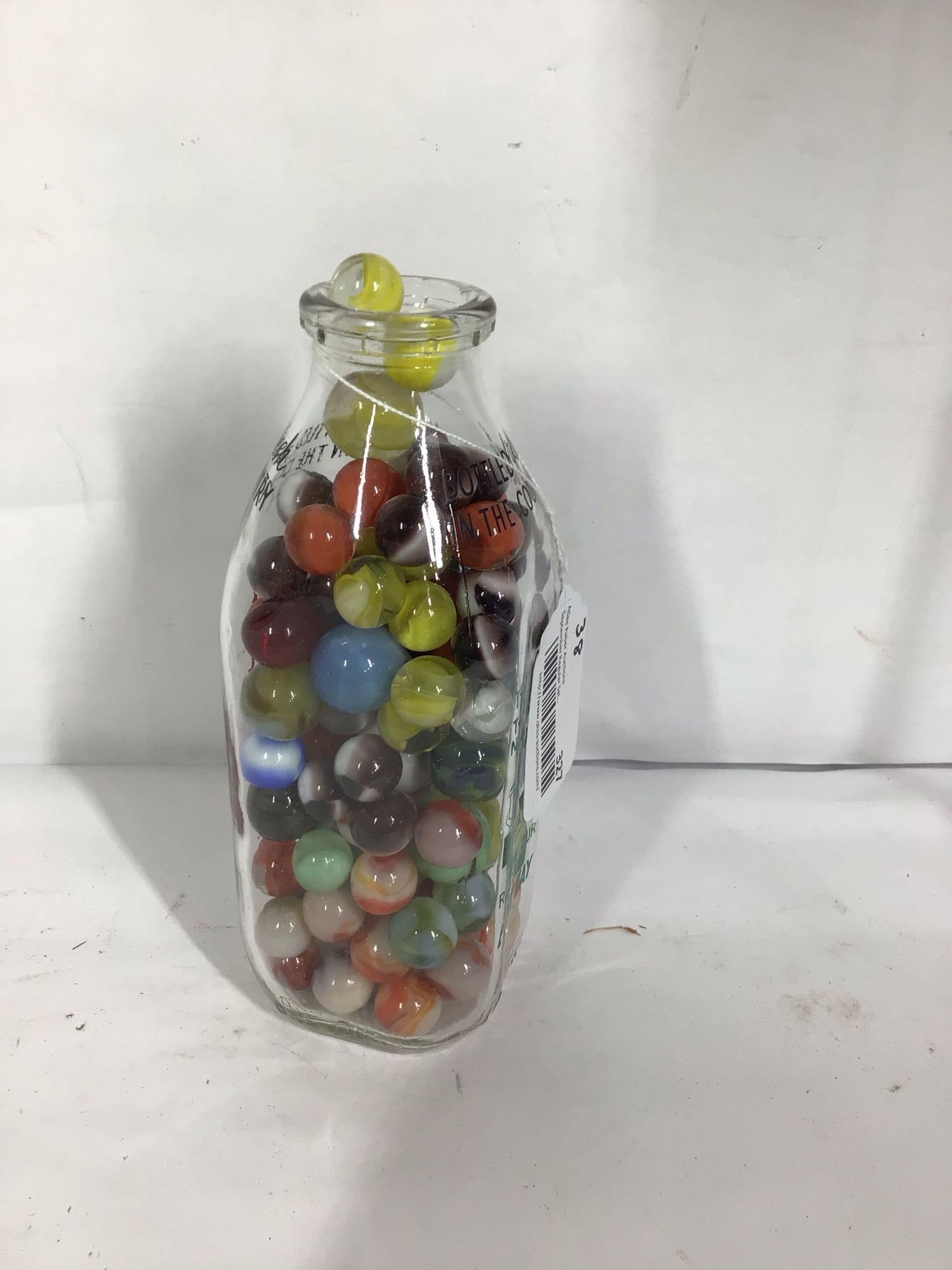 Dashiell Dairy milk bottle with various size marbles: .