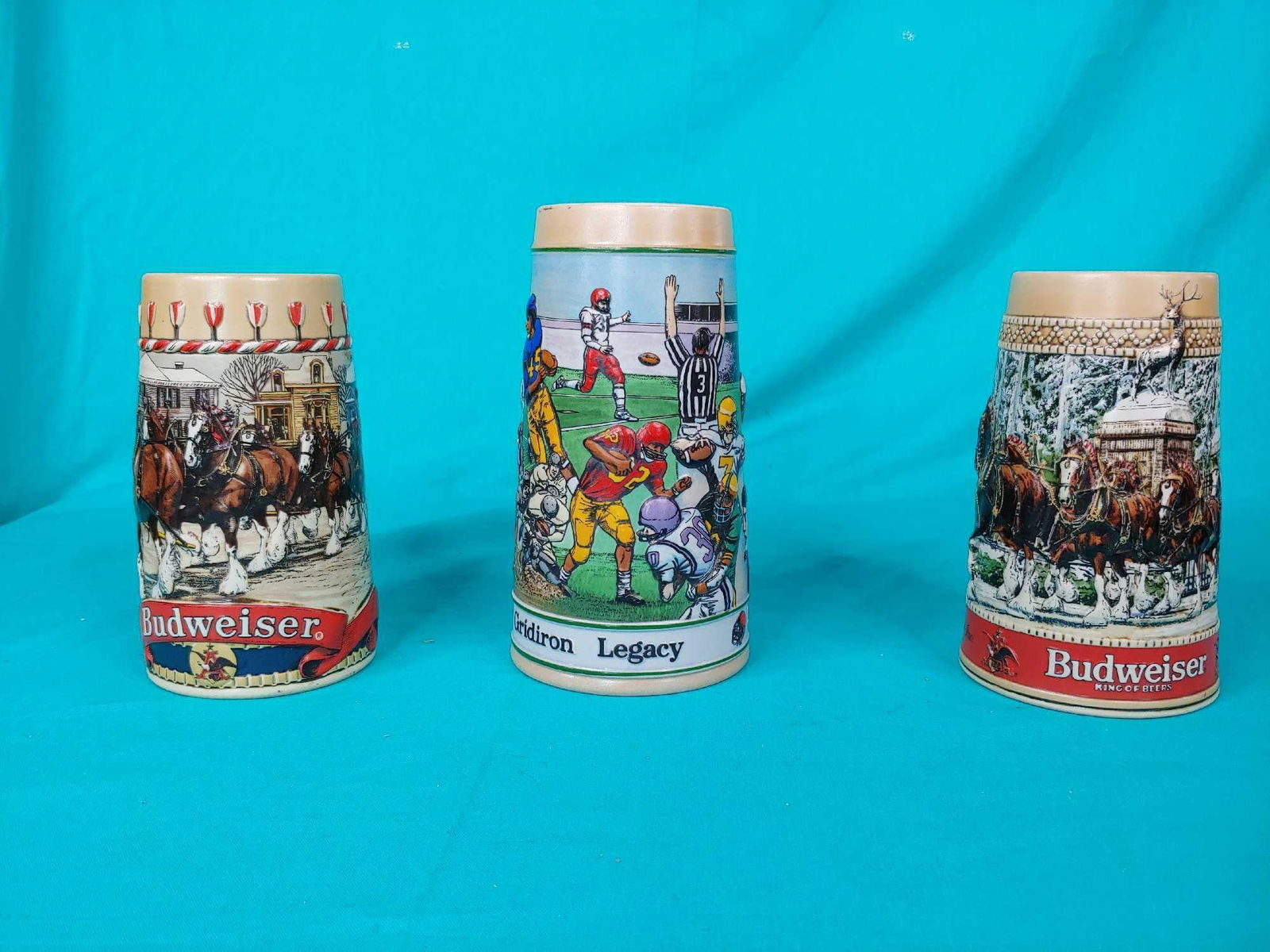 three Budweiser beer steins: Each is different tallest is 7.5 in tall other two are6.5 in tall