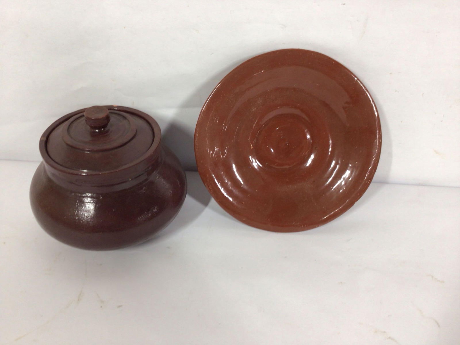 REDWARE LIDDED URN AND PLATE: BOTH HAVE VERY MINOR FLAKES.
