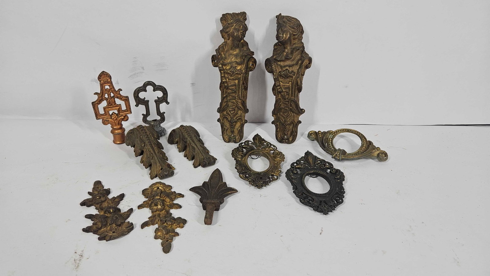 CAST IRON AND BRASS EMBELLISHMENTS AND DETAIL: INCLUDES ROMAN FIGURES, CORNER PIECES, FINIALS, DOOR KNOCKER AND MORE.