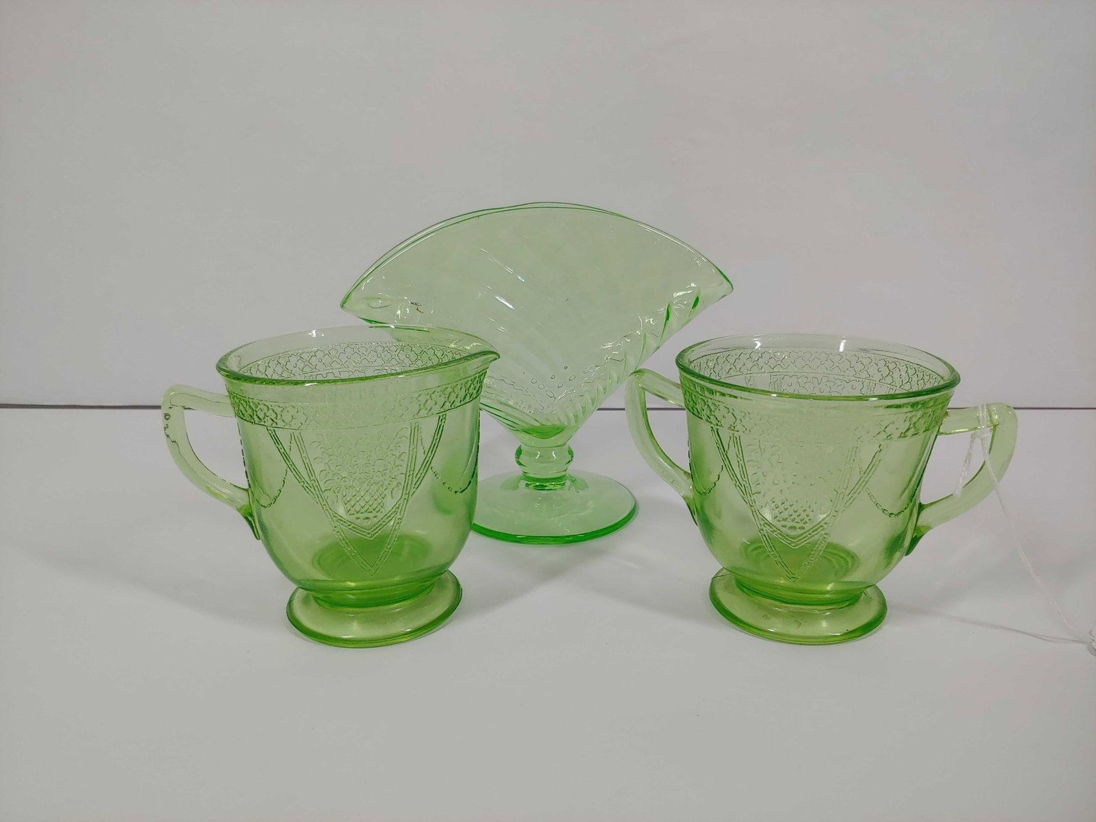 GEORGIAN LOVEBIRDS URANIUM CREAMER, SUGAR DISH, AND FOLDED VASE: EACH PIECE GLOWS GREEN UNDER UV LIGHT. NO CHIPS OR CRACKS FOUND.