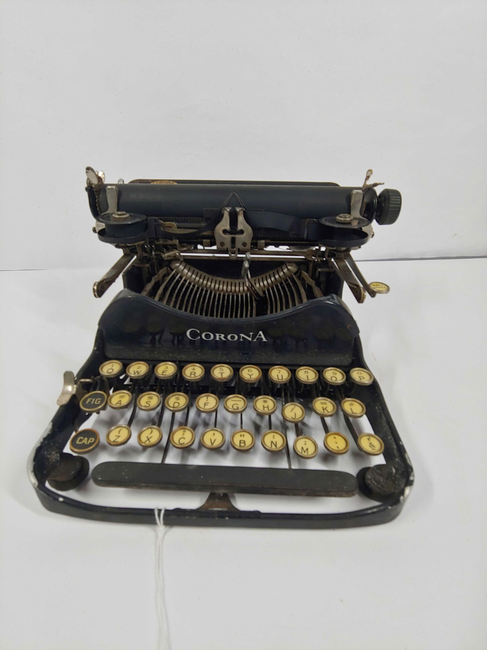 CORONA TYPEWRITER: KEYS ALL WORK BUT SOME REMAIN STUCK. SMALLER MODEL. ONLY MEASURE 9X8X6